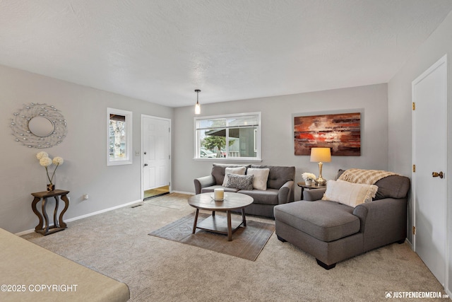 carpeted living area featuring baseboards