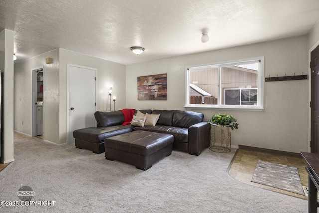 living area featuring carpet flooring, a textured wall, baseboards, and a textured ceiling