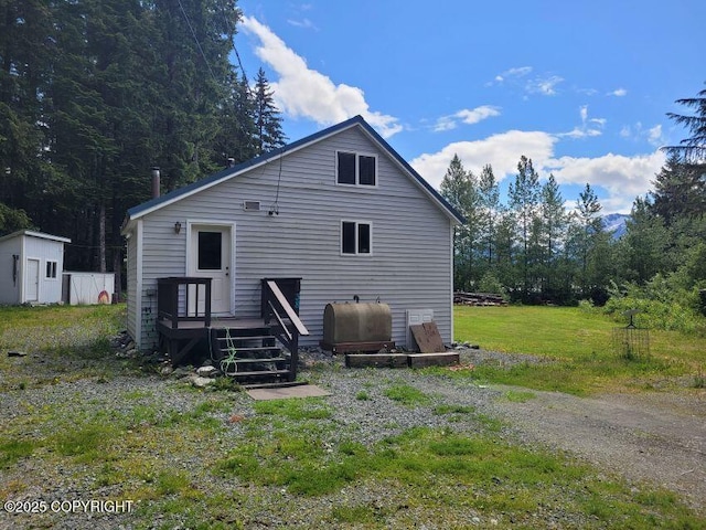 38 Helms Loop Spur, Haines, AK 99827 - back of house featuring oil tank and a wooden deck