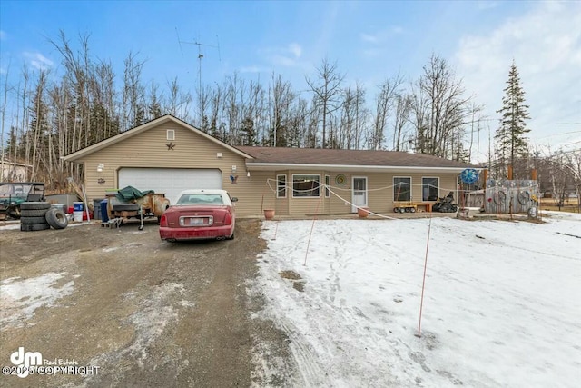 ranch-style home with an attached garage, a wooden deck, and driveway