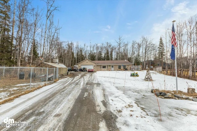 view of front of property with fence and a garage