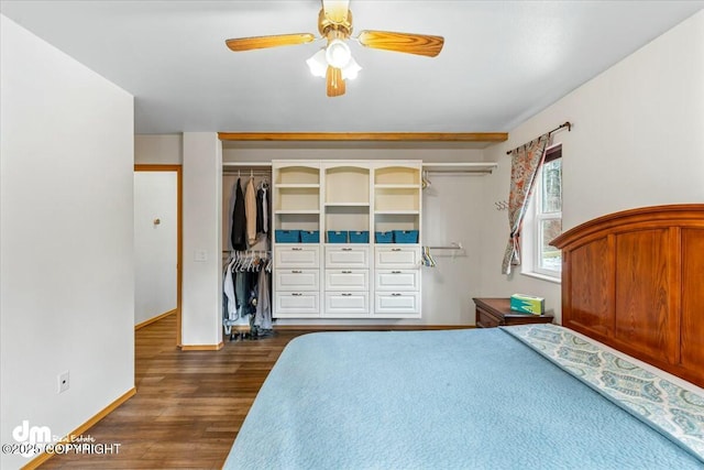 bedroom with a ceiling fan, dark wood-style floors, and baseboards