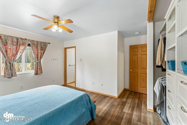 bedroom with ceiling fan, baseboards, and wood finished floors