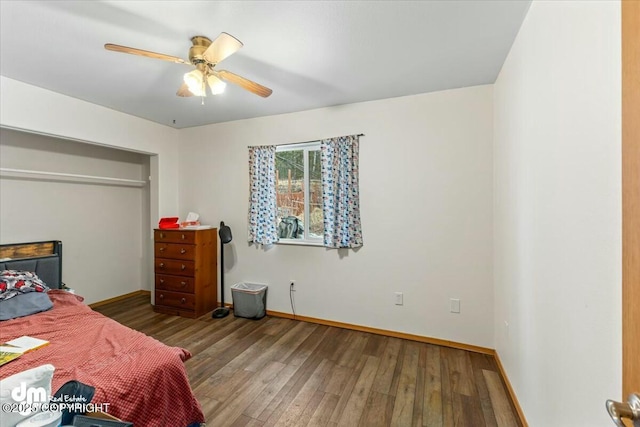 bedroom with ceiling fan, baseboards, and wood finished floors