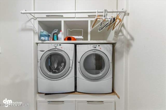 laundry room featuring washing machine and dryer and laundry area