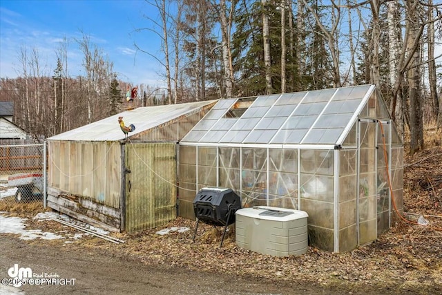 view of greenhouse featuring fence