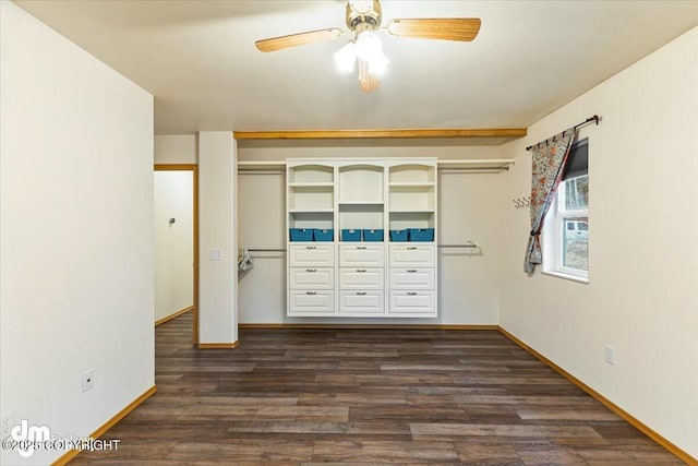 unfurnished bedroom featuring ceiling fan, baseboards, dark wood-type flooring, and a closet