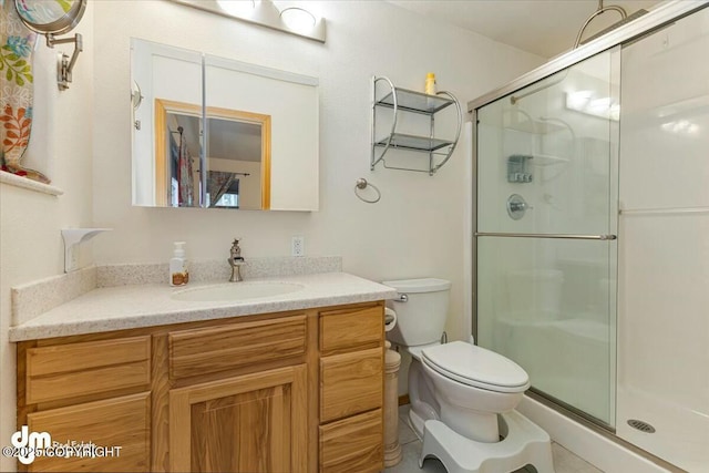 full bathroom with a shower stall, toilet, and vanity