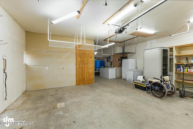 garage with freestanding refrigerator and a garage door opener