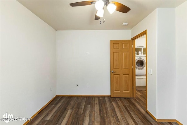 unfurnished room with a ceiling fan, baseboards, dark wood-style flooring, and washer / clothes dryer