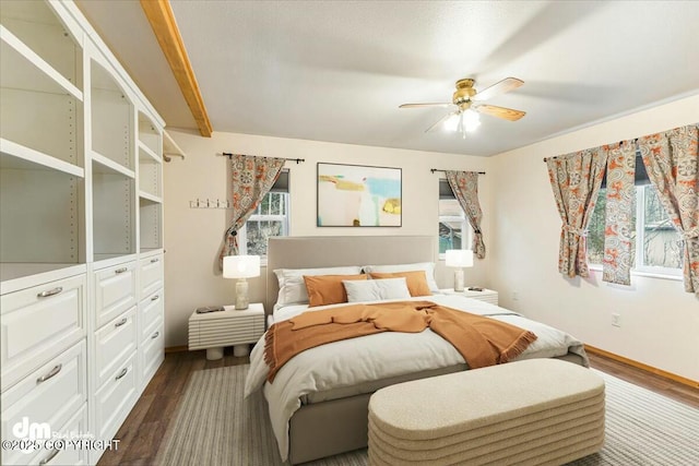 bedroom featuring ceiling fan, baseboards, and dark wood-style flooring