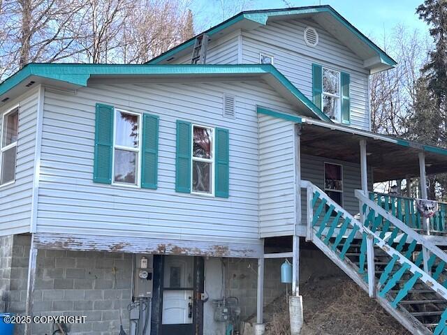 view of side of property with covered porch