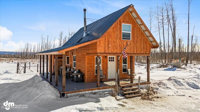 exterior space with covered porch and metal roof