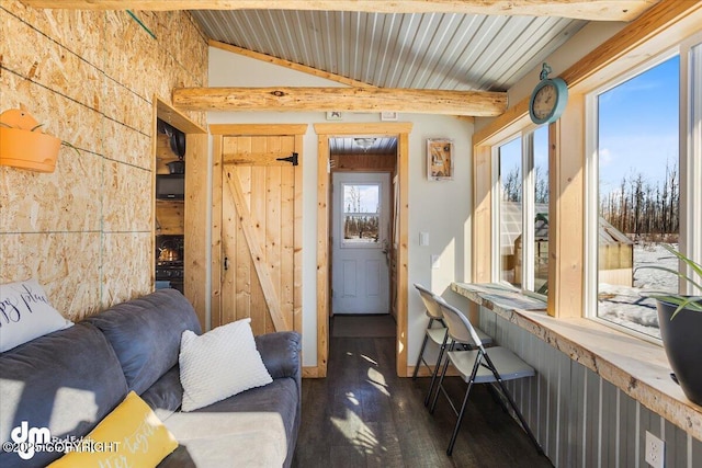 living room with vaulted ceiling with beams, wood finished floors, and wooden ceiling