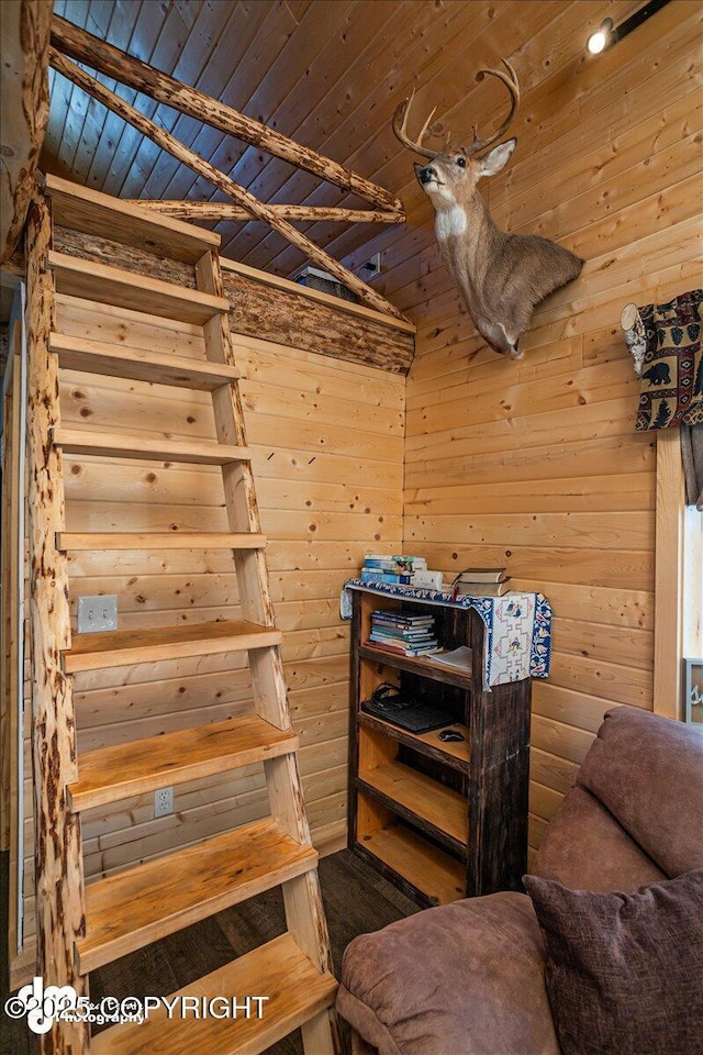 staircase featuring wooden ceiling and wood walls