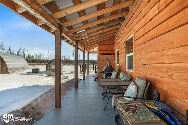 view of patio / terrace with an outbuilding and a greenhouse