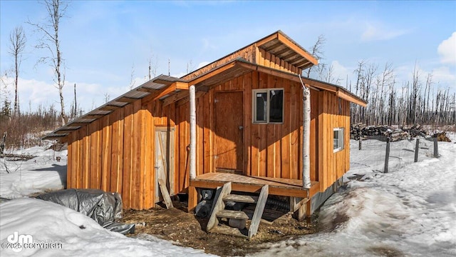 snow covered structure featuring an outdoor structure