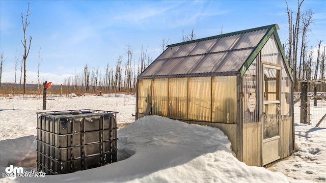 snow covered structure with an exterior structure and an outdoor structure