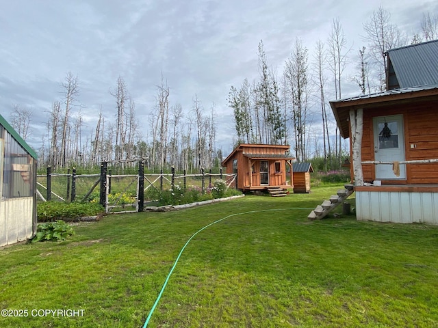 view of yard featuring an outbuilding and fence