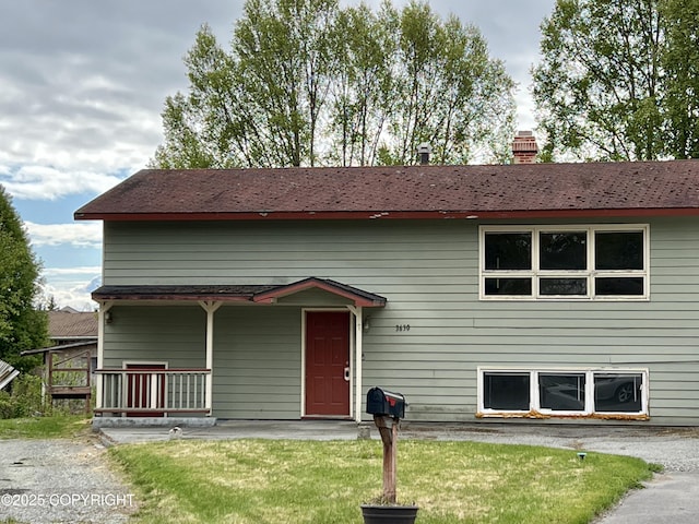 3630 Dunkirk Ct, Anchorage, AK 99502 - view of front facade with a chimney and a front yard