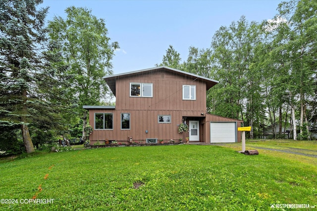 rear view of property featuring a lawn