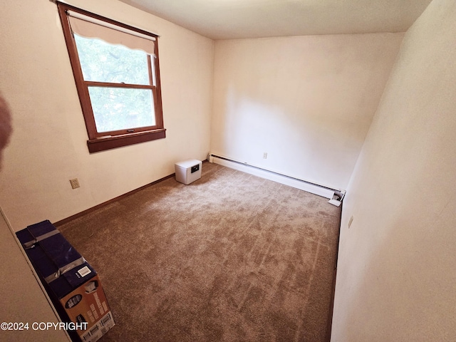 empty room with baseboards, carpet flooring, and a baseboard heating unit