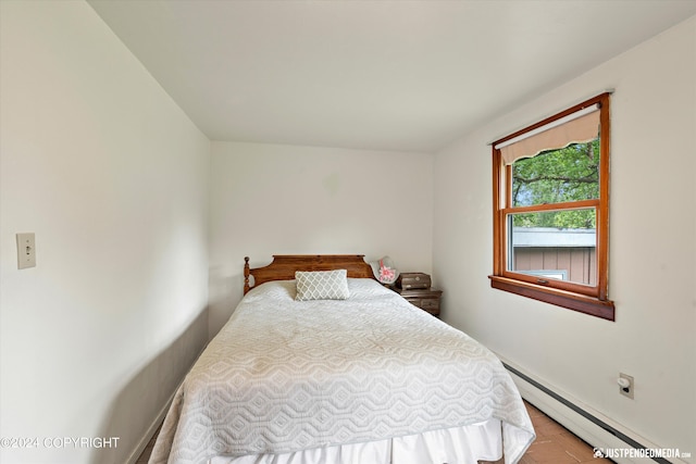 bedroom featuring baseboards and a baseboard heating unit
