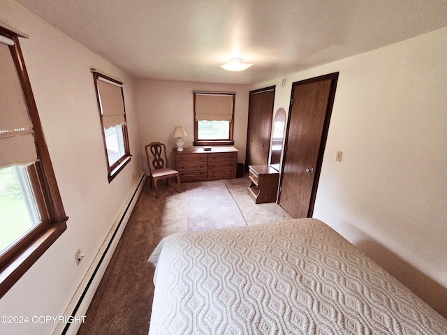 unfurnished bedroom featuring light colored carpet, multiple closets, and a baseboard radiator