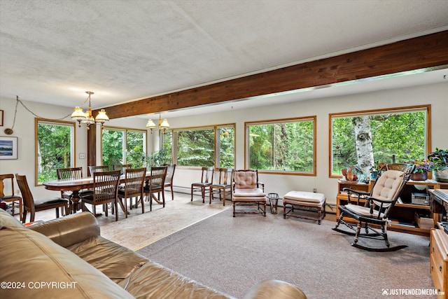 living area featuring a textured ceiling, an inviting chandelier, and a wealth of natural light