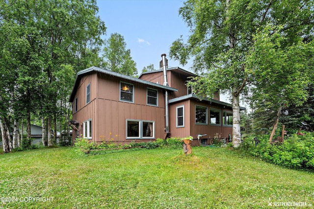 back of house with a yard