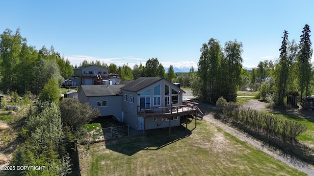 3583 S Peninsula Dr, Wasilla, AK 99623 - rear view of house with a wooden deck and driveway