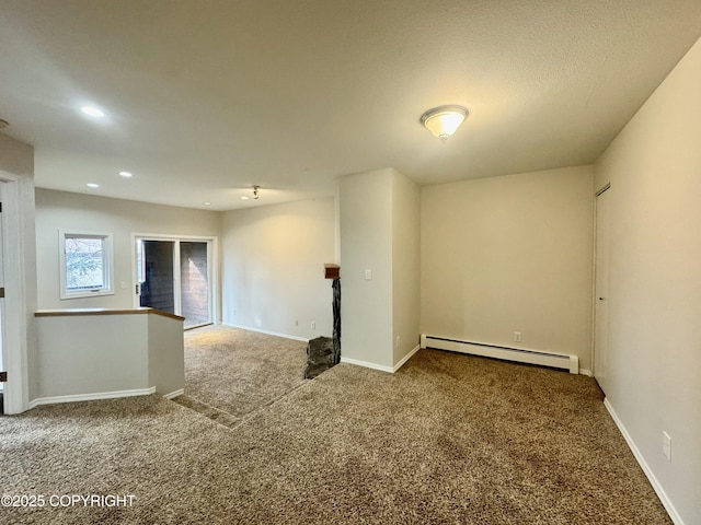 empty room featuring recessed lighting, baseboards, carpet floors, and a baseboard radiator
