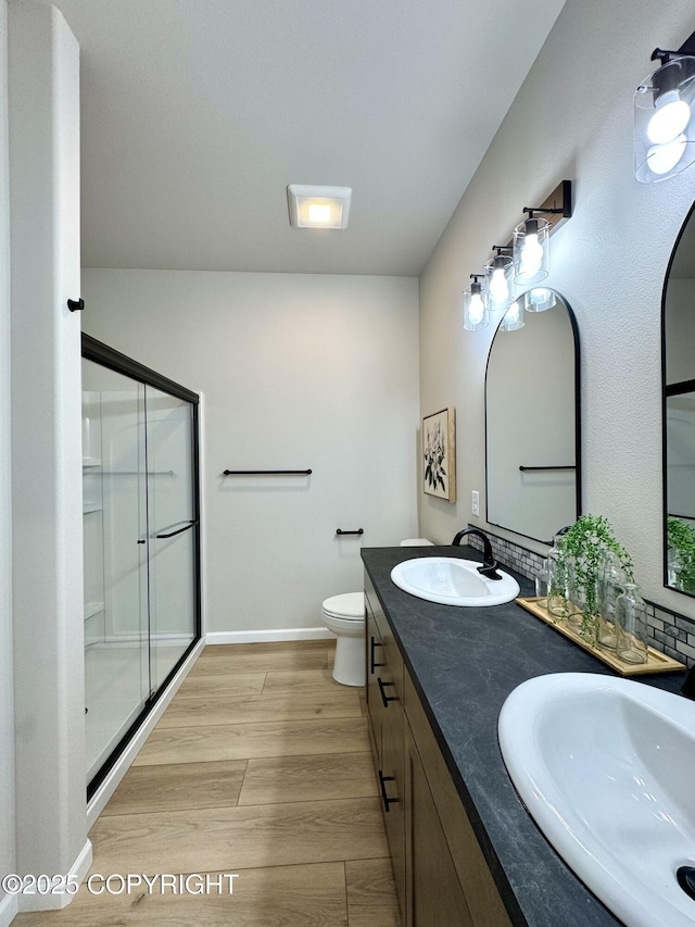 698 Wortham Ave, Kenai, AK 99611 - full bathroom with a shower stall, double vanity, and wood finished floors
