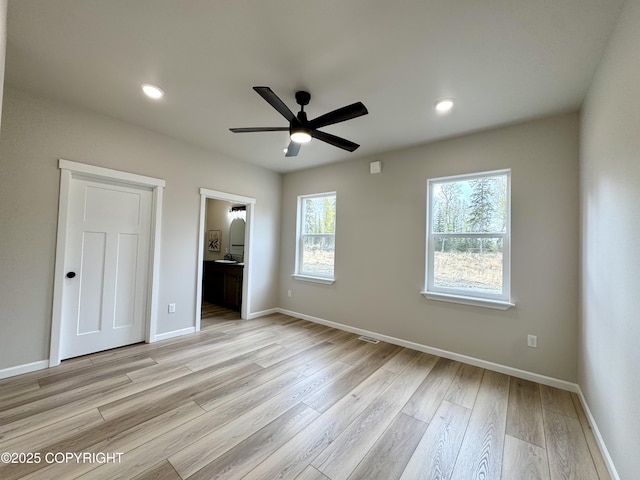 698 Wortham Ave, Kenai, AK 99611 - unfurnished bedroom featuring light wood-style floors, ensuite bath, a ceiling fan, and recessed lighting
