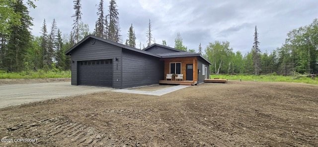 698 Wortham Ave, Kenai, AK 99611 - view of front facade featuring an attached garage, driveway, and a deck