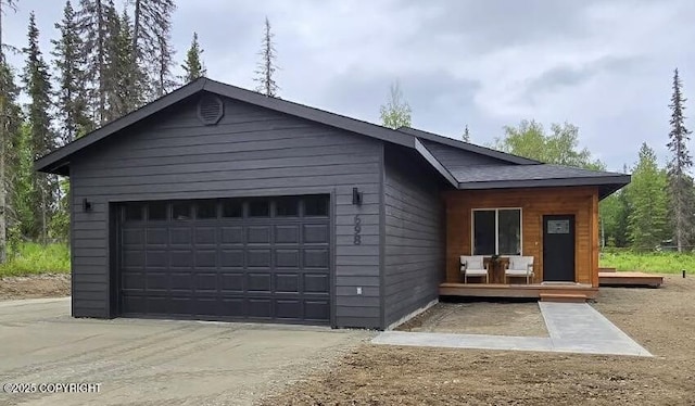698 Wortham Ave, Kenai, AK 99611 - view of front of property with a garage, a deck, and concrete driveway