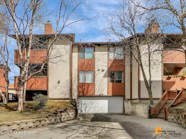 view of property with an attached garage and driveway