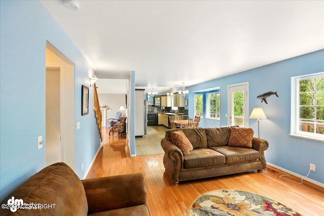 19016 Mountain Point Cir, Eagle River, AK 99577 - living area featuring light wood-type flooring, a chandelier, and baseboards