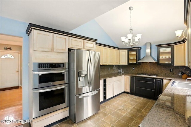 19016 Mountain Point Cir, Eagle River, AK 99577 - kitchen featuring wall chimney range hood, stainless steel appliances, a chandelier, a sink, and decorative backsplash