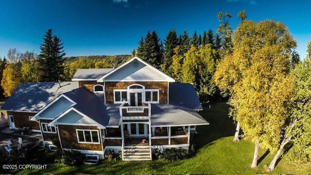 2727 Kachemak Dr, Homer, AK 99603 - rear view of house featuring a balcony, a sunroom, and a lawn