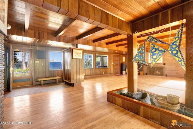 204 E 15th Ave, Anchorage, AK 99501 - living room with wood walls, wooden ceiling with exposed beams, wood finished floors, and a baseboard heating unit