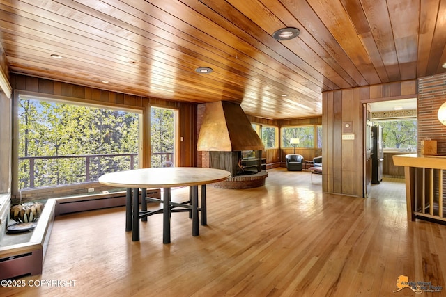 204 E 15th Ave, Anchorage, AK 99501 - dining area with wood ceiling, wood walls, hardwood / wood-style flooring, and a wood stove