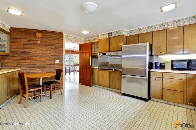 204 E 15th Ave, Anchorage, AK 99501 - kitchen featuring stainless steel appliances, light countertops, and brown cabinetry
