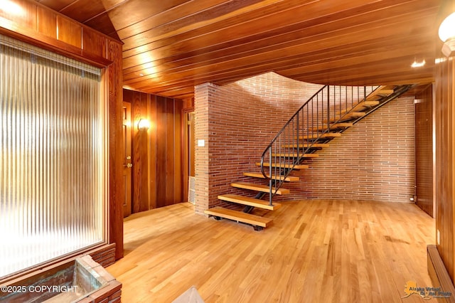 204 E 15th Ave, Anchorage, AK 99501 - staircase with wood ceiling, brick wall, wood finished floors, and wooden walls