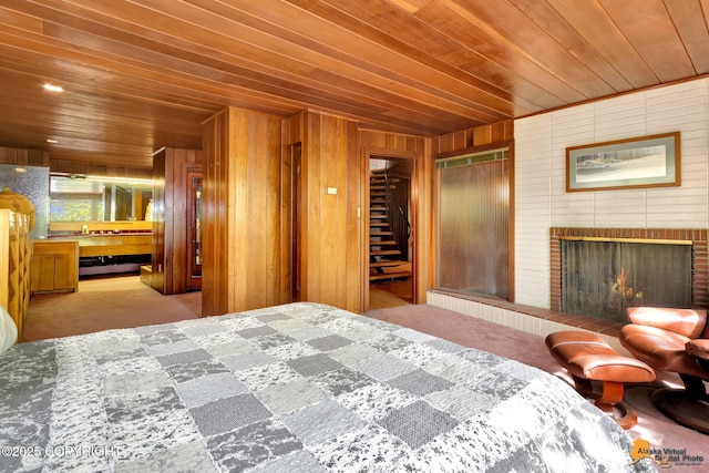 204 E 15th Ave, Anchorage, AK 99501 - carpeted bedroom featuring wood ceiling, wooden walls, and a fireplace