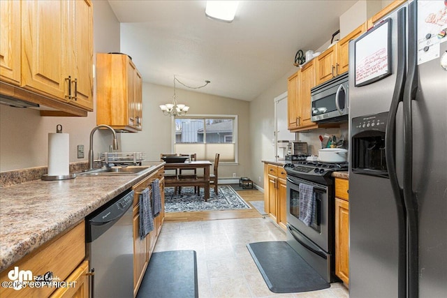 4801 Carousel Cir, Anchorage, AK 99502 - kitchen featuring vaulted ceiling, a chandelier, stainless steel appliances, a sink, and hanging light fixtures