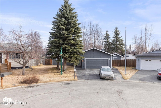 4801 Carousel Cir, Anchorage, AK 99502 - view of front of home featuring board and batten siding, a detached garage, and fence