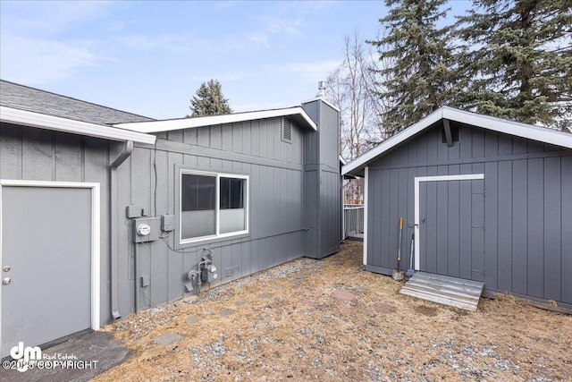 4801 Carousel Cir, Anchorage, AK 99502 - view of side of home featuring a storage unit and an outdoor structure