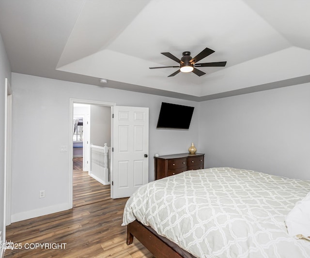 25656 Bendilent Cir, Eagle River, AK 99577 - bedroom with a raised ceiling, wood finished floors, baseboards, and a ceiling fan