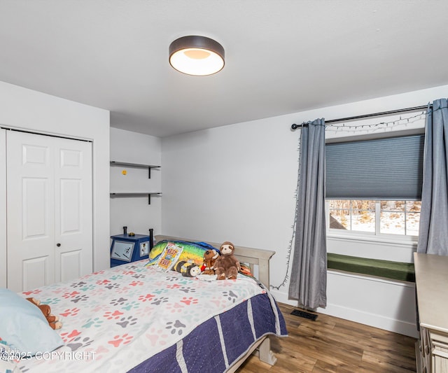 25656 Bendilent Cir, Eagle River, AK 99577 - bedroom featuring visible vents, a closet, baseboards, and wood finished floors